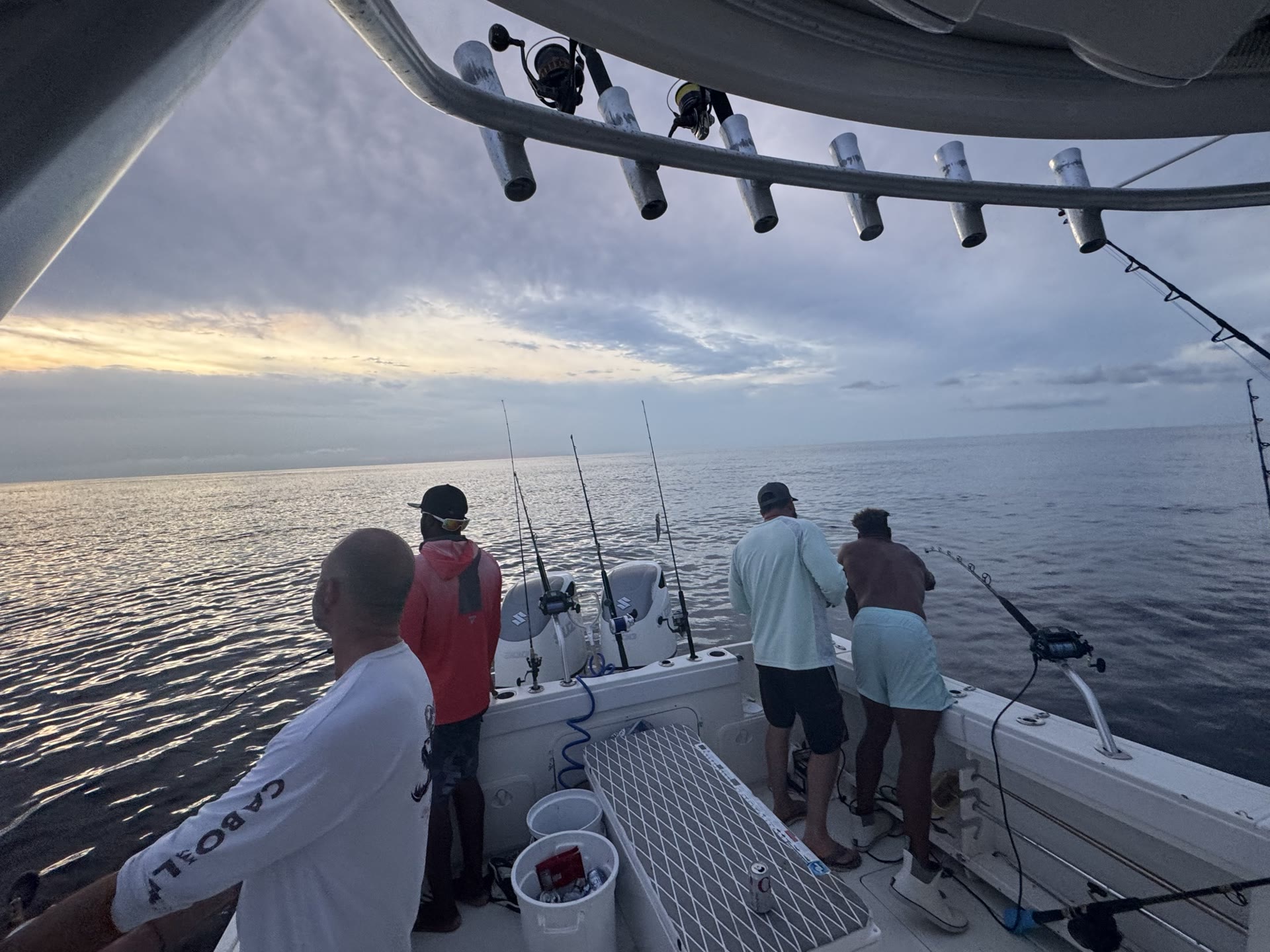 Four anglers fishing off the stern of Capt. Travis Trotter's boat at dawn, 40 miles offshore of Panama City